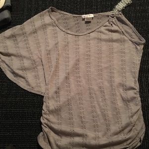 Gray one shoulder shirt.